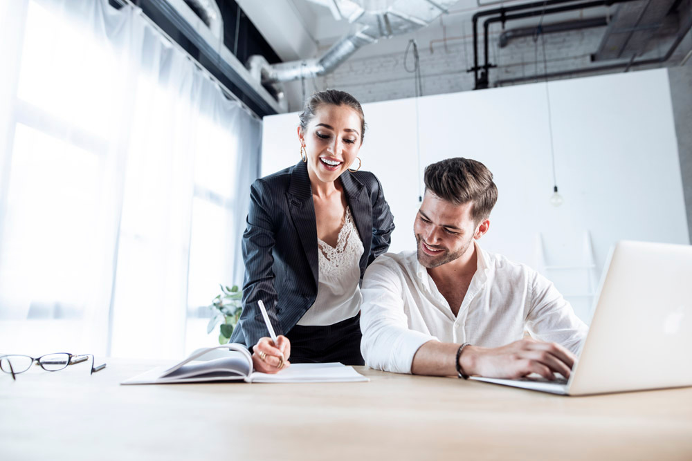 Commercial lifestyle photograph of two colleagues working together